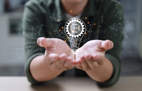 The hand of an entrepreneur holding a light bulb: inspiration for sustainable business development and a modern strategic business problem-solving approach.