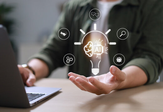The hand of an entrepreneur holding a light bulb: inspiration for sustainable business development and a modern strategic business problem-solving approach.