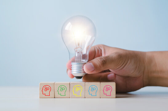 New business ideas and strategic consulting. Mobile wooden block with light bulb icon. Brainstorming creativity and expertise.