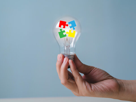 New business ideas and strategic consulting. Mobile wooden block with light bulb icon. Brainstorming creativity and expertise.