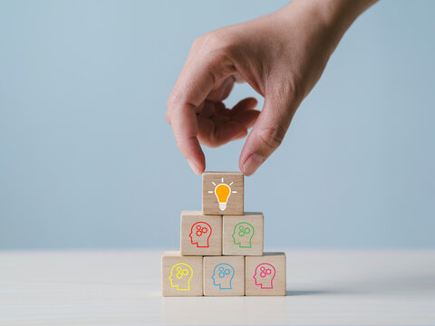 New business ideas and strategic consulting. Mobile wooden block with light bulb icon. Brainstorming creativity and expertise.