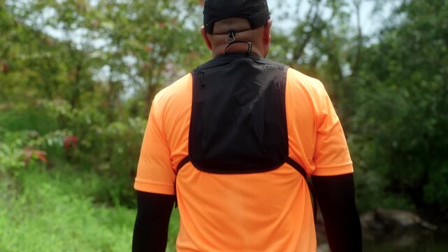 Man trail running through a mountain forest. Extreme outdoor workout represents endurance, personal challenge and determination while pursuing fitness goals and a healthy active lifestyle.
