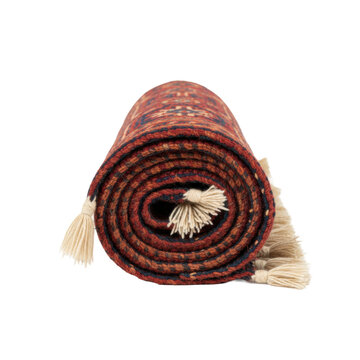 A tightly rolled vintage Persian tapestry displaying intricate madder red and navy geometric patterns, hand-tied tassels on a bright white background, symbolizing timeless craftsmanship and elegance