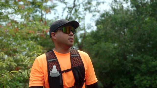 Man trail running through a mountain forest. Extreme outdoor workout represents endurance, personal challenge and determination while pursuing fitness goals and a healthy active lifestyle.
