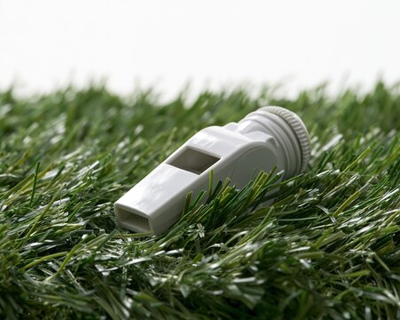 Whistle in the Grass: A Whistle Resting on Artificial Turf