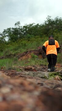 Man trail running through mountains during an extreme outdoor workout. Scene represents endurance, personal challenge and determination while pursuing fitness goals, achievement an active lifestyle.
