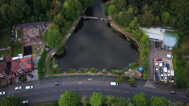 Aerial Video of Blackley Vale Pond, Blackley New Road, and Woodland in Manchester