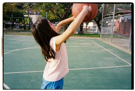 Young Girl Playing Basketball. Outdoor Court. Film