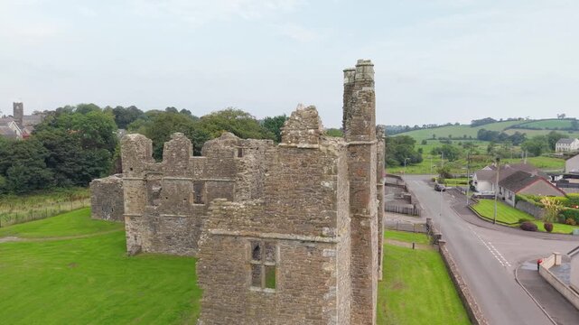 Close aerial pass along the mullioned windows and ruined tower of Castle Caulfield, Castlecaulfield, County Tyrone, Northern Ireland