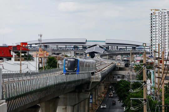 Skytrain Travels on an elevated Track in Urban Area During Afternoon