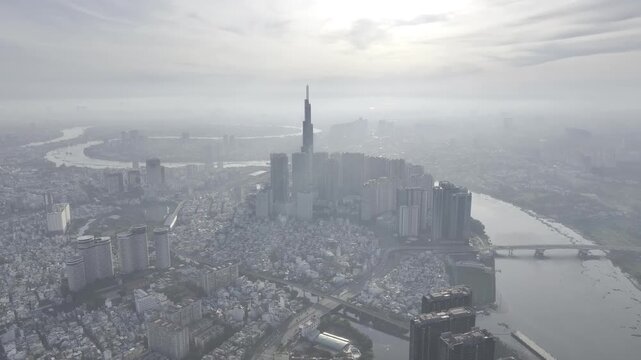 Aerial drone view of Landmark 81 in Thanh My Tay Ward, Ho Chi Minh City, Vietnam, with bright sunlight illuminating the iconic skyscraper and surrounding modern urban landscape.