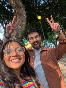 Friends raising hands with peace gestures