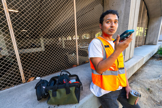 construction worker in city talking on mobile phone