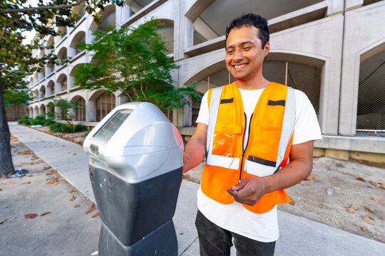 working paying parking meter city sidewalk