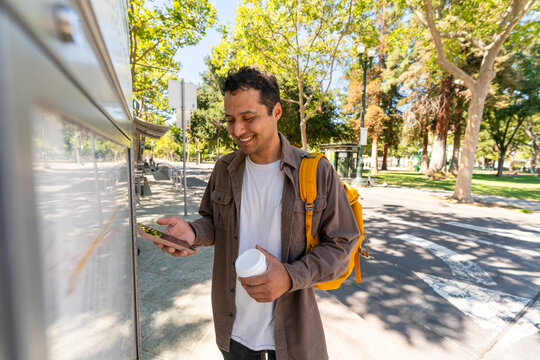 casual man looking at public transportation map navigation