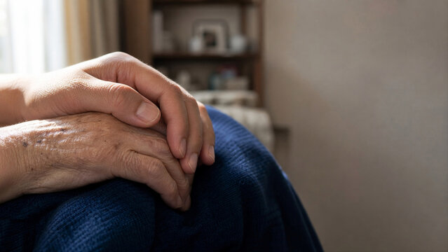 Young Adult Hand Squeezing Elderly Parent Hand - Senior Care Reassurance Macro - Healthcare SaaS Banner - Natural Morning Window Light

