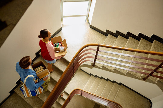 Couple climbs up the stairs inside the building