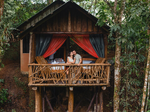 Couple embracing on rustic cabin balcony in costa rica