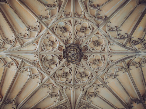 The intricate fan-vaulted ceiling and central pendant boss beneath Anne Boleyn's Gateway (or the Clock Court gatehouse) at Hampton Court Palace, London