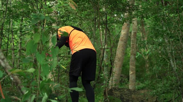 Man trail running through a forest during an outdoor workout. He challenges himself to improve fitness and endurance while pursuing personal goals and a healthy active lifestyle.

