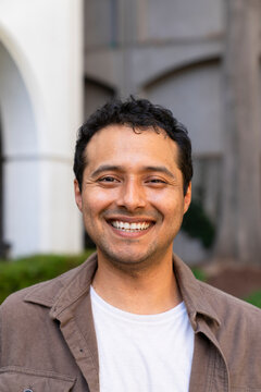 headshot of man looking at camera smiling