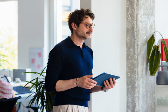 Businessman Using Tablet In Modern Office