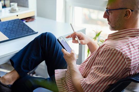 Man Using Smartphone at Office