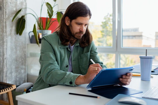 Man Working On Tablet at Office