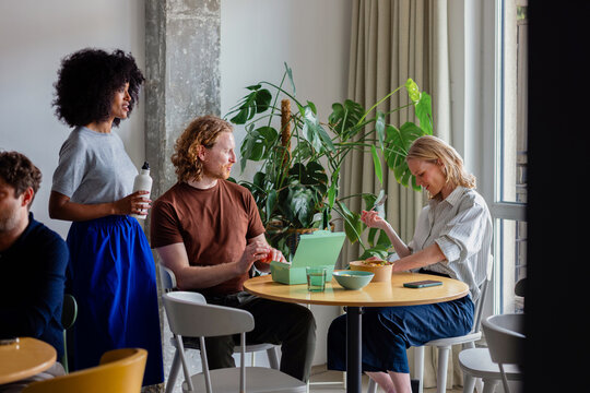 Colleagues Sharing Lunch Break in Modern Office