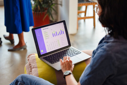 Person Working On Laptop With Business Analytics Dashboard