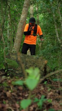 Man trail running through a forest during an outdoor workout. He challenges himself to improve fitness and endurance while pursuing personal goals and a healthy active lifestyle.
