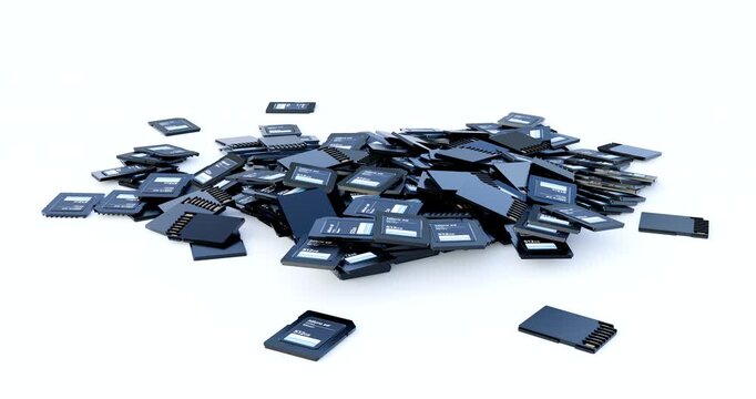 Pile of black micro sd memory cards dropping and accumulating on clean white background