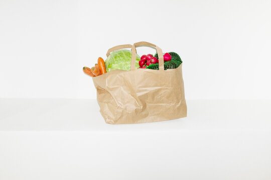 Food grocery store delivery in a brown paper bag in the hallway