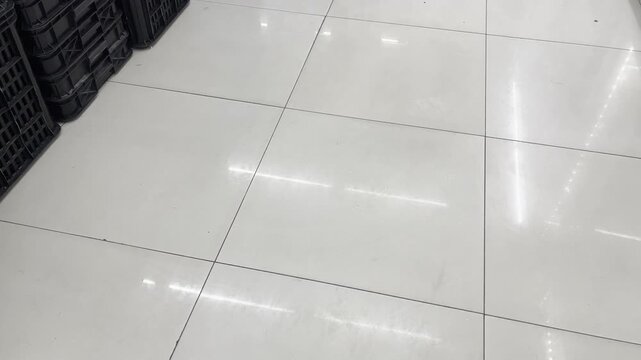 Clean white ceramic floor tiles texture with reflection
