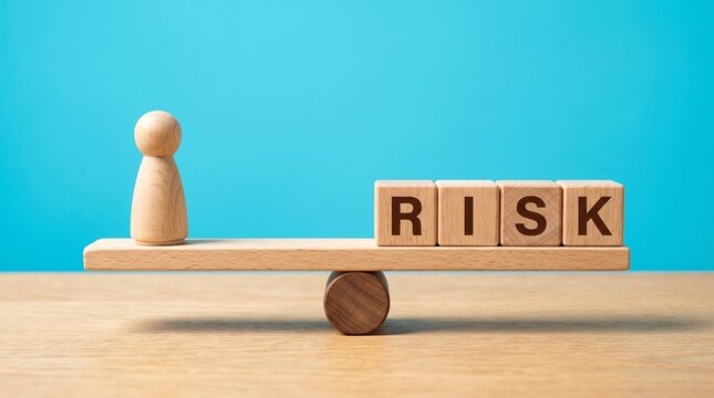 A wooden seesaw balancing a human figurine on one side and wooden blocks spelling "RISK" on the other, against a blue background.