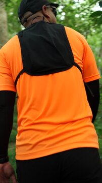 Man trail running through a forest during an outdoor workout. He challenges himself to improve fitness and endurance while pursuing personal goals and a healthy active lifestyle.
