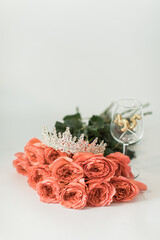 Coral Rose Arrangement with Tiara and Golden 35 Decoration on White Background © Daisy Heart