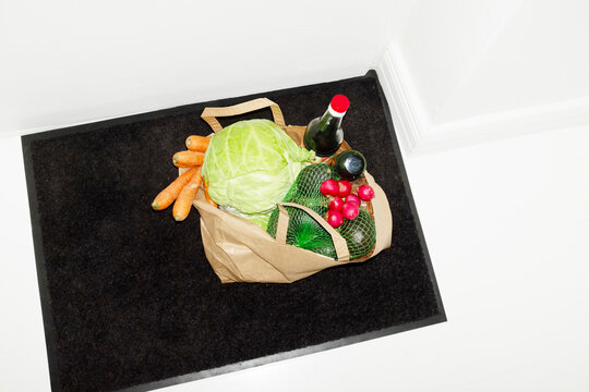 Food grocery store delivery in a brown paper bag in the hallway