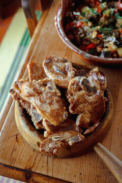 Grilled Meat and Vegetable Dish on a Wooden Table