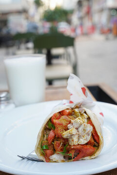 Traditional Izmir sogus street food wrap with ayran in Turkey