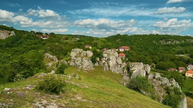 Lush green hills roll under a bright blue sky. Vrmdza Fortress. Serbia