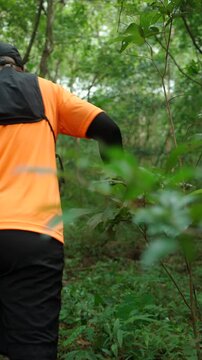 Man trail running through a forest during an outdoor workout. He challenges himself to improve fitness and endurance while pursuing personal goals and a healthy active lifestyle.
