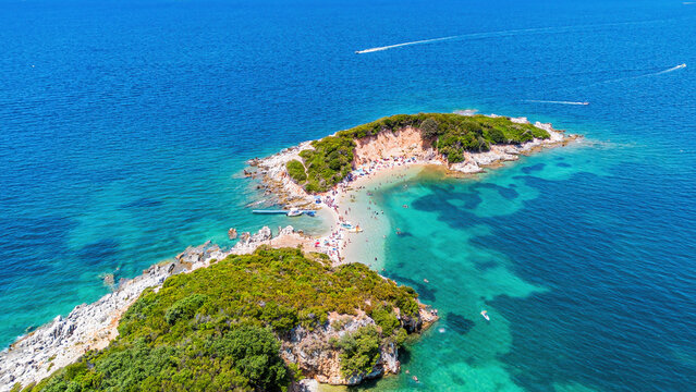 Aerial drone view of the twin Ksamil islands (Ishujt Binjak&euml;), turquoise waters, and scenic coastline in southern Albania