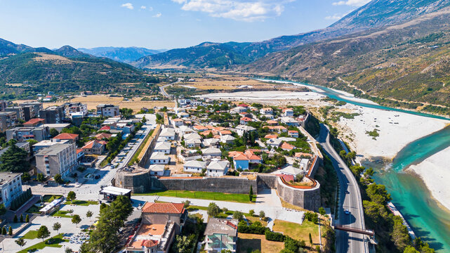 Aerial drone view of Tepelene Castle, surrounding town, and the Vjosa River valley in Albania