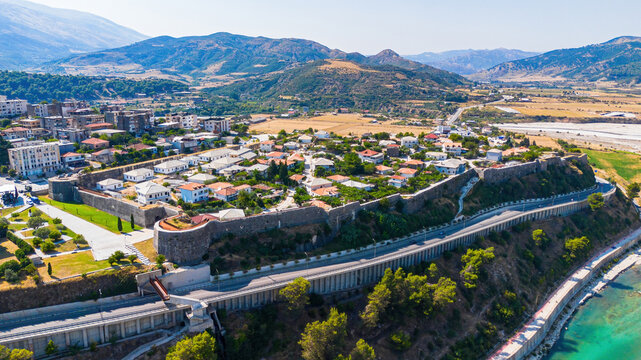 Aerial drone view of the historic Tepelene Castle walls, town, and the Vjosa River valley in Albania