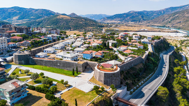 Aerial drone view of the historic Tepelene Castle walls, town, and the Vjosa River valley in Albania