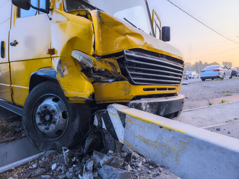 Damaged yellow commercial vehicle after accident in Kyrgyzstan