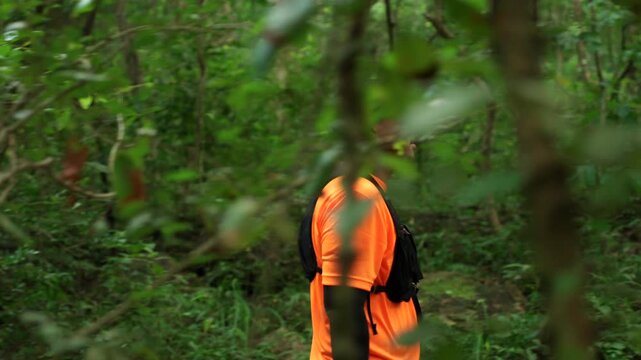 Determined man trail running through a forest during an extreme outdoor workout. He pushes his limits while pursuing fitness goals, endurance personal achievement through an active healthy lifestyle.
