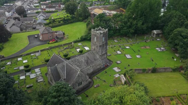 High angle aerial looking down on St Michael's Church of Ireland and the headstones of its graveyard, Castlecaulfield, County Tyrone, Northern Ireland