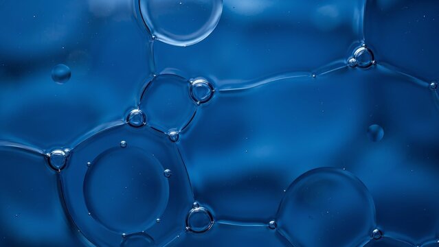 Abstract blue oil and water bubbles macro background for science or technology concepts